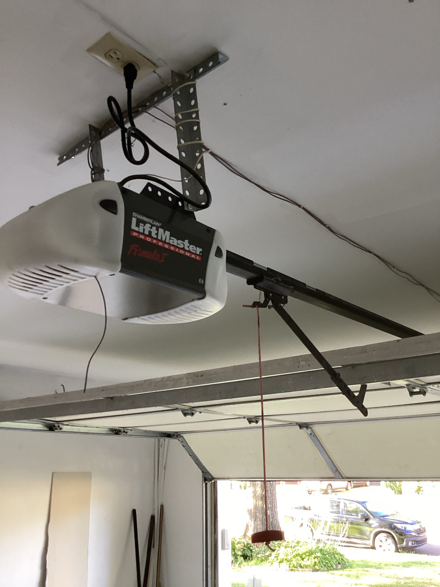 LiftMaster garage door opener mounted to the garage ceiling with its rail connected to the door